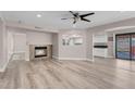 Open-concept living area with a fireplace, neutral color palette, and access to the backyard at 42 Megan Dr, Henderson, NV 89074