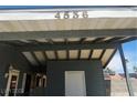 A sheltered carport with a white door featuring the home's street number: 4536 at 4536 Payson Ave, Las Vegas, NV 89115