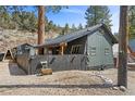 Charming home featuring distinctive architecture, a fenced yard, and mature trees, offering a serene and inviting atmosphere at 4578 Yellow Pine Ave, Mount Charleston, NV 89124