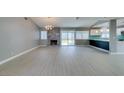 Open-concept living room featuring a modern fireplace, gray walls and sliding glass doors to the backyard at 4731 Torrence Dr, Las Vegas, NV 89103
