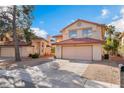 Charming two-story home with stucco siding, desert landscaping, and a two-car garage at 4817 Friar Ln, Las Vegas, NV 89130