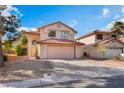 Exterior view of a charming two-story home with desert landscaping and an attached two-car garage at 4817 Friar Ln, Las Vegas, NV 89130