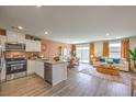 Open-concept kitchen with stainless appliances, quartz countertops, and a seamless flow to the living area at 4828 Lilac Ridge Ave # 26, Las Vegas, NV 89141