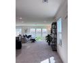 Bright living room with plush carpet, natural light, and modern decor at 4993 Birchland Manor Ave, Las Vegas, NV 89139