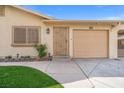 Close-up of the home's entrance, showcasing the well-kept lawn and a convenient attached garage and carport at 5001 Morris St, Las Vegas, NV 89122