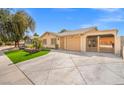 Spacious driveway leading to a charming single-story home with a well-maintained lawn and attached carport at 5001 Morris St, Las Vegas, NV 89122