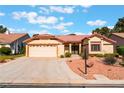 Charming one-story home featuring a well-maintained lawn, two-car garage, and desert landscaping at 5029 Pacific Grove Dr, Las Vegas, NV 89130