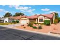 Charming single-story home featuring a well-manicured front yard, two-car garage, and desert landscaping at 5029 Pacific Grove Dr, Las Vegas, NV 89130