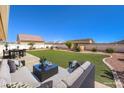 Spacious backyard featuring a plush lawn, patio seating and manicured landscaping at 5231 E Chasemoor St, Pahrump, NV 89061
