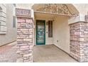 Inviting front entrance with decorative stone pillars and an ornate iron security door at 5409 Holding Ave, Las Vegas, NV 89139