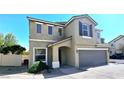 Two-story tan home with a two-car garage, covered entry, and well-kept landscaping at 6348 Blue Twilight Ct, Las Vegas, NV 89108