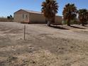 View of the side of a single-story home with palm trees at 675 Stevens Ave, Overton, NV 89040