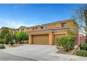 Beautiful two-story home with a three-car garage, terracotta tile roof, and desert landscaping at 7216 Campolina Ct, Las Vegas, NV 89113