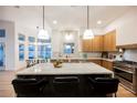 Modern kitchen featuring a large marble island, stainless steel appliances, and ample counter space at 7695 Silver Wells Rd, Las Vegas, NV 89149