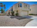 Stucco two-story home has desert landscaping and a two-car garage at 8329 Telescope Peak Ct, Las Vegas, NV 89145