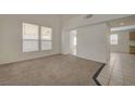Bright living room with carpet and tile flooring leading to other rooms at 8329 Telescope Peak Ct, Las Vegas, NV 89145
