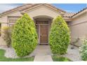 Close up view of a home's front door surrounded by manicured landscaping and decorative shrubbery at 8912 Galena Crossing St, Las Vegas, NV 89123
