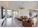 Open-concept living area with large windows, neutral color scheme, and modern furnishings at 9780 Solar Ave, Las Vegas, NV 89149