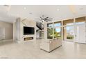 Open-concept living room with fireplace, staircase, and abundant natural light at 9780 Solar Ave, Las Vegas, NV 89149
