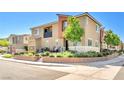 Townhouse showcasing manicured desert landscaping, neutral colors, and a covered balcony for outdoor enjoyment at 12126 Azure Gate Rd # 1, Las Vegas, NV 89183