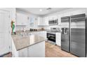 Well-lit kitchen offering stainless steel appliances, white cabinets, and solid surface countertops at 12126 Azure Gate Rd # 1, Las Vegas, NV 89183