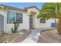 Cozy home with a welcoming walkway and easy-care desert landscaping at 1252 N Sloan Ln, Las Vegas, NV 89110