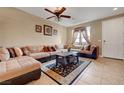 Spacious living room featuring a plush sectional sofa, ceiling fan and neutral-toned walls at 1547 Harwood Ave, Henderson, NV 89012