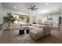 Open living room boasts a large sectional sofa and a view of the beautifully landscaped backyard at 1624 Preston Park Dr, Henderson, NV 89052