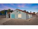Side view of a single-story home with updated facade and low-maintenance yard at 1775 Esteban Ave, Laughlin, NV 89029