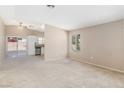 Spacious living room with neutral carpet, lots of light, and views of the backyard at 1775 Esteban Ave, Laughlin, NV 89029