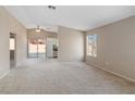 Bright and airy living room with a view into the kitchen and sliding door to the backyard at 1775 Esteban Ave, Laughlin, NV 89029