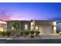 Modern home exterior showcasing a well-manicured front yard and a two-car garage at 18 Via Tiberina, Henderson, NV 89011
