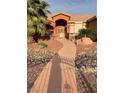 Charming home featuring desert landscaping and a walkway to the front door at 210 Lailani St, Las Vegas, NV 89110