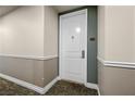 Apartment 1305 front door displaying a modern design with neutral colors and a visible unit number at 2260 Village Walk Dr # 1305, Henderson, NV 89052