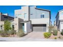 Modern two-story home features a gray color scheme, stone accents, and a two-car garage at 2510 Verdello St, Henderson, NV 89044