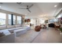 Bright, open living space features a large sectional sofa and view to the kitchen at 2510 Verdello St, Henderson, NV 89044