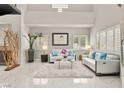 Bright living room boasts high ceilings, neutral decor, large windows and stylish modern furniture at 2608 Sun Reef Rd, Las Vegas, NV 89128