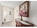 Bright entryway with tiled floors, console table, and sidelight window by the front door at 2645 Heritage Ct, Las Vegas, NV 89121
