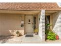 View of the front door entrance with a security gate and low maintenance desert landscaping at 2645 Heritage Ct, Las Vegas, NV 89121