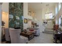 An open-concept living room with high ceilings, a fireplace, and staircase to the second floor at 2649 Golden Sands Dr, Las Vegas, NV 89128