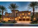 Majestic stone house with a three-car garage, second-story balconies, and lush landscaping at 2845 Red Arrow Dr, Las Vegas, NV 89135