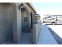 Side view of the home showing the covered front porch, decorative lights, and the RV parking area at 3020 Peggy Ave, Pahrump, NV 89048