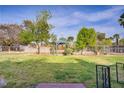 Large grass backyard with a gazebo and mature landscaping at 3100 Garehime St, Las Vegas, NV 89108