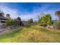 Expansive backyard featuring a well-maintained lawn, mature trees, and ample space for outdoor activities at 3100 Garehime St, Las Vegas, NV 89108