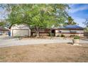 Charming single-story home featuring an attached garage, mature shade trees and drought-resistant landscaping at 3100 Garehime St, Las Vegas, NV 89108