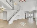 Bright entryway featuring a staircase and tile flooring that leads to the living area at 3444 Trilogy Dr, Las Vegas, NV 89108