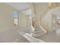 Spacious foyer with a winding staircase and tile flooring at 3755 Broadmead St, Las Vegas, NV 89147