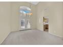 Bright, open-concept living room with French doors and neutral carpet at 3755 Broadmead St, Las Vegas, NV 89147
