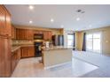 Open kitchen with stainless steel appliances, granite countertops, and an adjacent living area at 380 Horsetail Falls St, Indian Springs, NV 89018