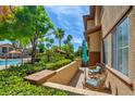 Enjoy the view from this lovely patio, with manicured landscaping, a glimpse of the pool, and comfortable seating at 3840 Belle Glade St # 104, Las Vegas, NV 89129